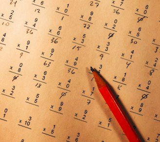 red pencil on top of mathematical quiz paper