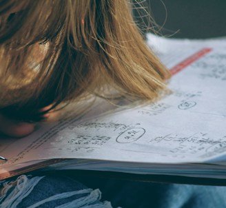 woman in blue denim jacket holding white paper